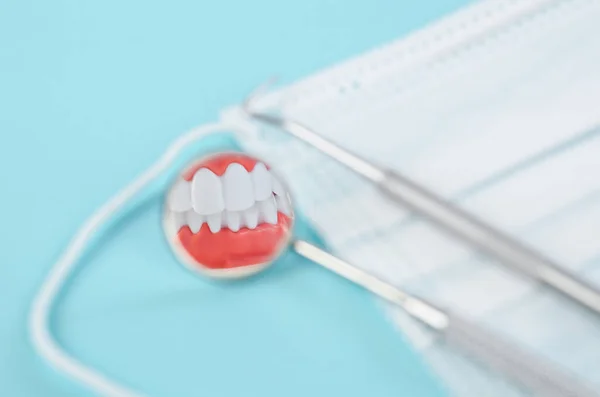 Focus white healthy teeth in mirror of dental equipment. Dental concept.