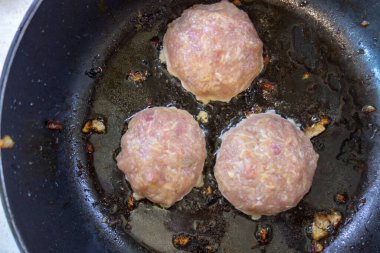 Kızartma tavasında pirzola için kırmızı kıyma.