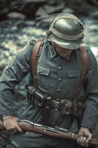 Finnish soldier of the second world war in an iron helmet with a rifle in his hands