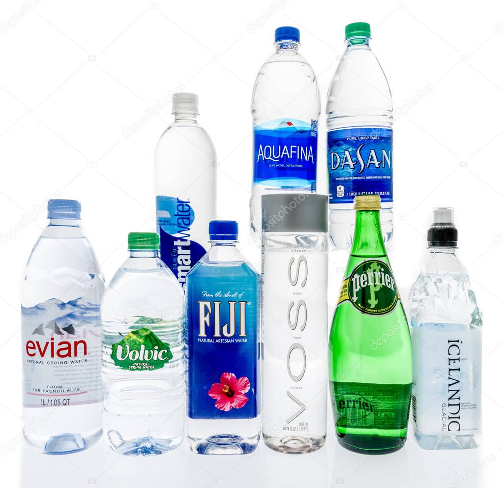Winneconne, WI - 10 January 2019:  A collection of worlds most popular water including evian, volvic, fuji, voss, perrier, icelandic, dasani, aquafina and smartwater on an isolated background.