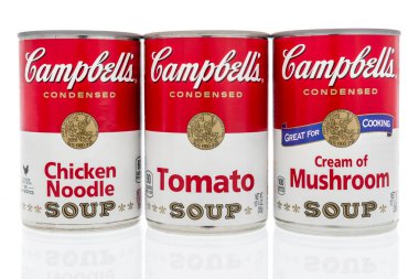 Winneconne, WI - 2 Feb 2019: A collection of Campbells soup in cream of mushroom, chicken noodle and tomato on an isolated background clipart