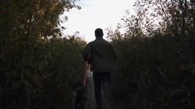 Adam güzel köpeğiyle birlikte bir bahar günü göle doğru koşar.