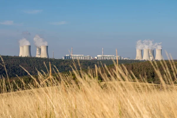Nuclear power plant in summer landscape under blue sky. Dukovany village, Czech Republic, Europe.