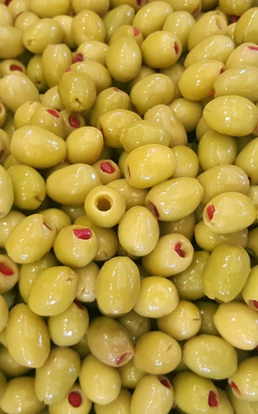 Closeup of stuffed pickled olives, food background.