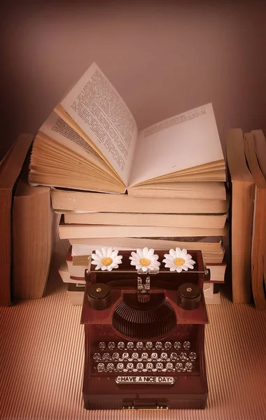 Vintage typewriter with books on table