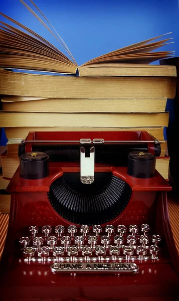 Vintage typewriter with books on table