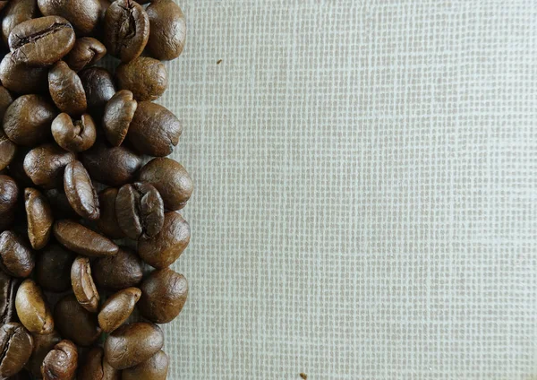 Border made of roasted coffee beans on linen textile