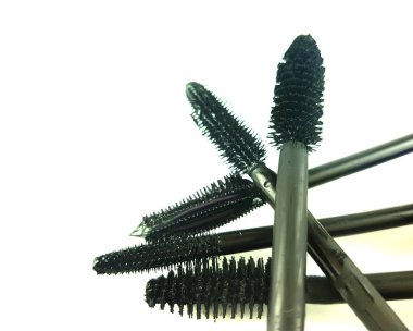 Variety of mascara brushes on copy space background clipart