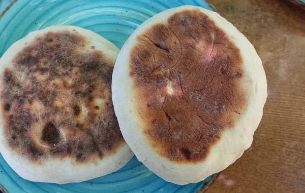 Two flat breads served on blue tray