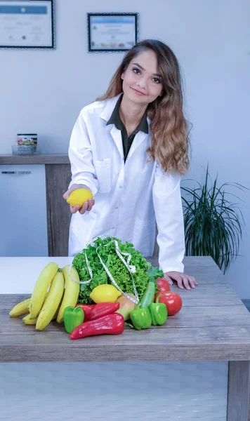 Dietitian doctor with healthy food in her office