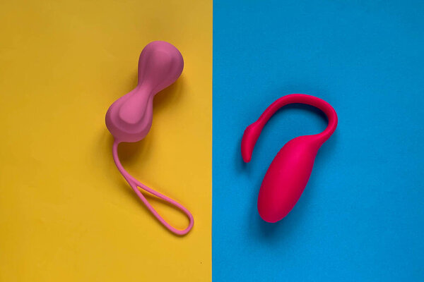 Sex toys. Vaginal balls on a yellow-blue background. Useful for sex shop, adults