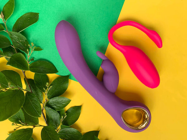 Sex toys. Two vibrators on a yellow background. Useful for adult, sex shop