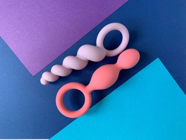 Sex toys. Two butt plag. Blue background. Useful for adult
