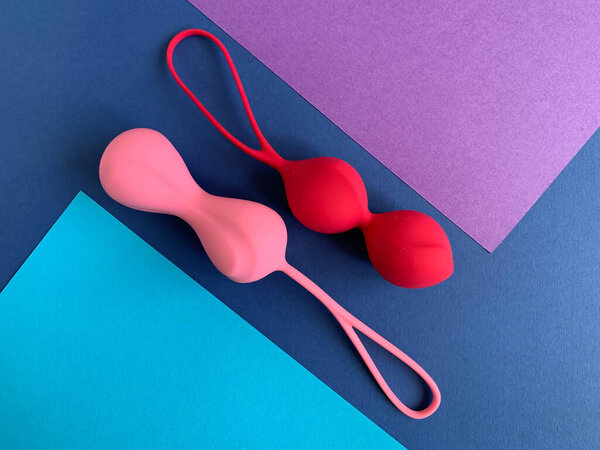 Sex toys. Two geisha balls on a colored background. Useful for sex shop, adult