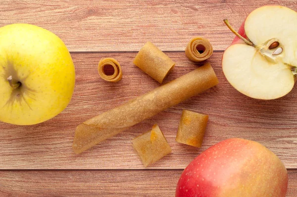 Homemade fruit leather of grape on a wooden background. Pastila. Fruit rolls. Fresh fruits