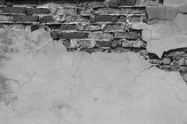 Old brick wall with fallen off plaster. Background of crack brick wall texture