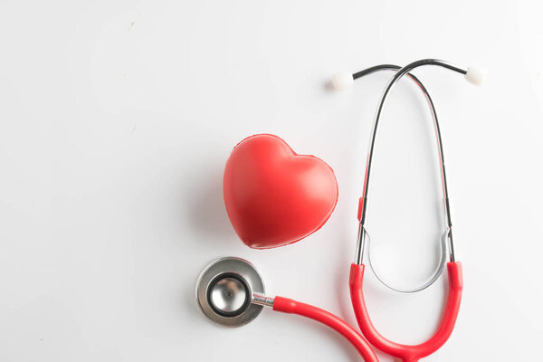 red heart and a stethoscope isolated on white background