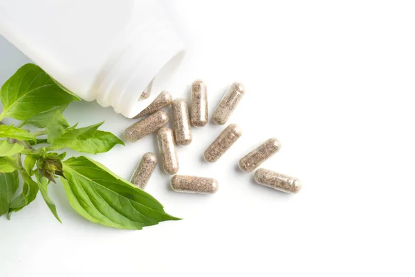 Herb Capsules Spilling Out Bottle White Background — Stock Photo, Image