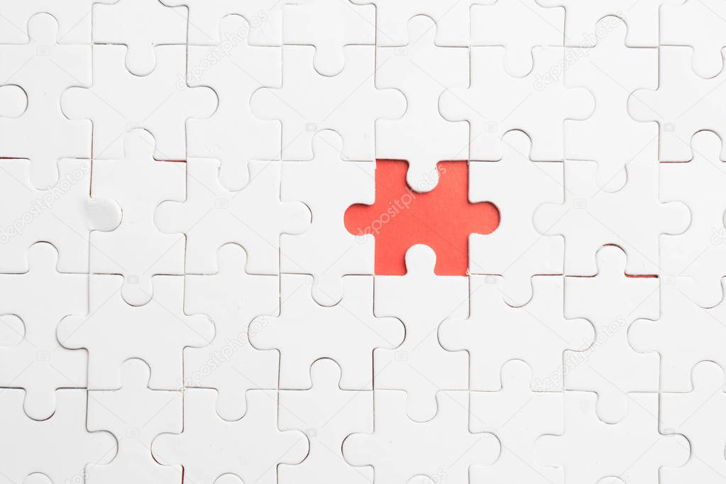 put the last piece of jigsaw puzzle to complete the mission on red background