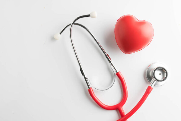 red heart and a stethoscope isolated on white background
