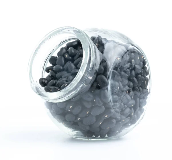 白色背景的玻璃瓶上的黑豆 — 图库照片