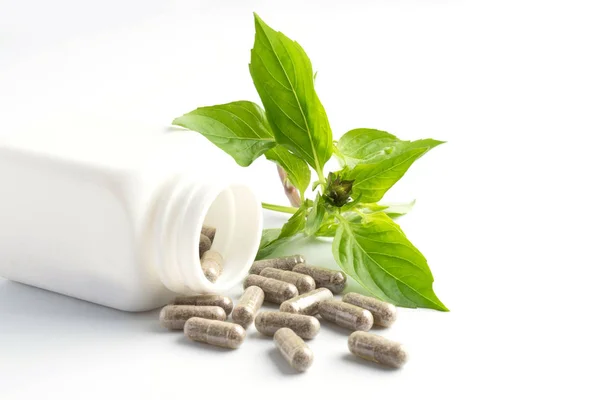 Herb Capsules Spilling Out Bottle White Background — Stock Photo, Image