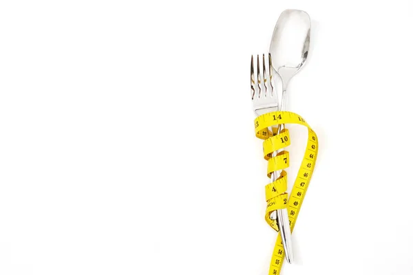 測定テープダイエットまたは健康的な食事概念を持つスプーンとフォーク — ストック写真