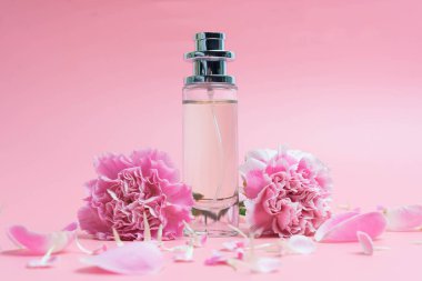 Pembe arka planda parfüm şişeleri