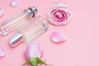 Pembe arka planda parfüm şişeleri