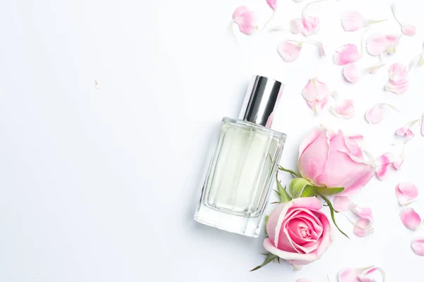 Perfume bottles and rose on white background — Stock Photo, Image