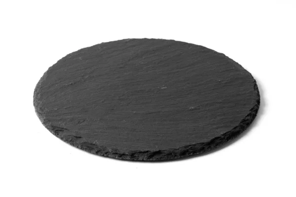 Black round stone plate isolated on white — Stock Photo, Image