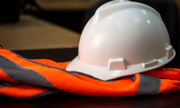 orange vest and hard hat