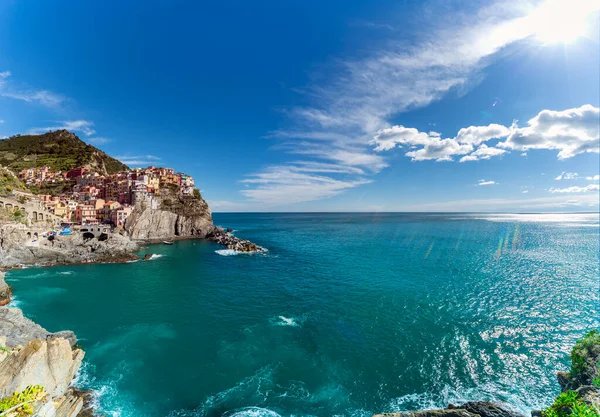 地中海のリグーリア海岸にあるイタリアのチンクテレの5つの村の1つであるManarolaは 晴れた夏の日にレンズフレアで虹色の太陽光線を作り出します — ストック写真