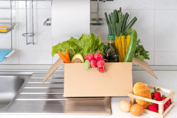 Donation box with superfoods fruits and vegetables. Sharing food concept. Food Delivery Volunteer collecting food. Coronavirus pandemic help. Front view