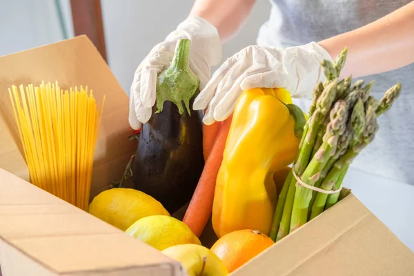 Donation box with superfoods fruits and vegetables. Sharing food concept. Food Delivery Volunteer collecting food. Coronavirus pandemic help. Top view