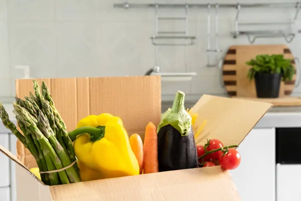 Donation box with superfoods fruits and vegetables. Sharing food concept. Food Delivery Volunteer collecting food. Coronavirus pandemic help. Top view