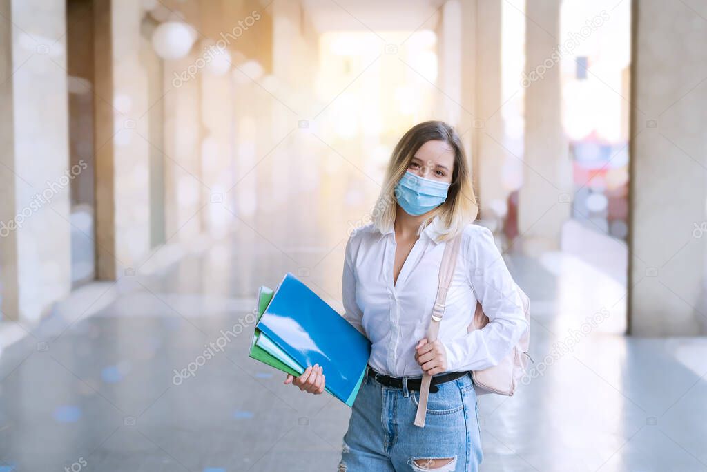 Female student or school girl in mask with backpack and exercise books over urban scene. Back to school. Studying after quarantine