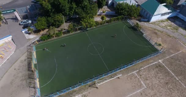 子供たちは 都市の古いスタジアム サッカーを遊んでいます 遊び場 暑い夏の日空撮 — ストック動画
