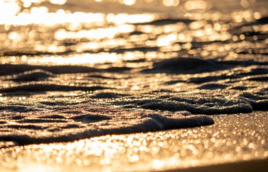 Dalgalar deniz kıyısına vuruyor Makro güneş doğuşunu kapatıyor