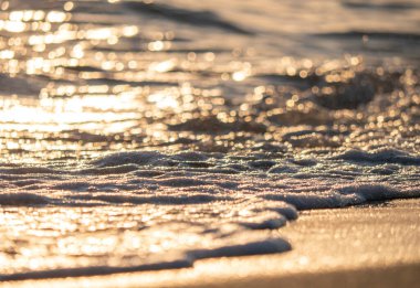 Dalgalar deniz kıyısına vuruyor Makro güneş doğuşunu kapatıyor