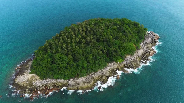 Aerial drone shot of Ko Pu desert island with palm trees and wild nature surrounded by turquoise sea water in Phuket, Thailand