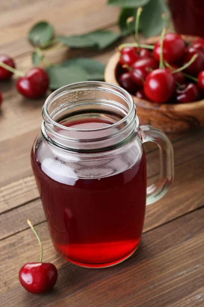 Cherry compote in a glass jar with a handle — Stock Photo, Image