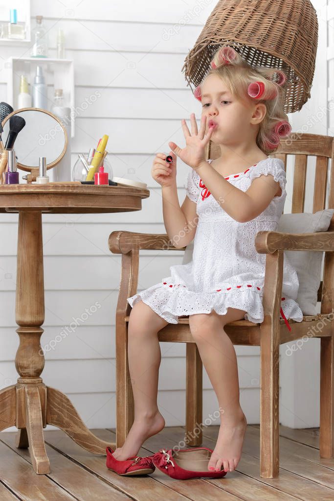 Little girl play in the beauty salon on the home terrace
