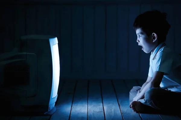 Boy watching TV at night