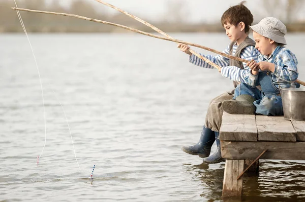 Les garçons pêchent sur un pont sur le lac — Photo