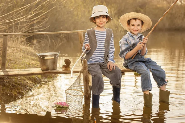 I ragazzi pescano su un ponte sul lago — Foto Stock