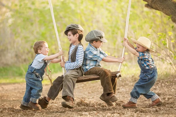 Children on swings sunny summer day — Stock Photo, Image