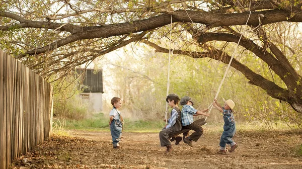 Children on swings sunny summer day — Stock Photo, Image