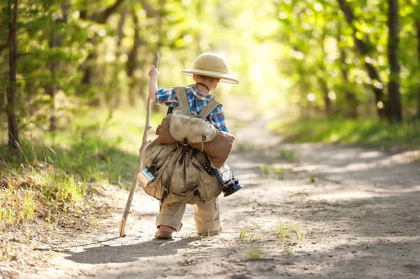 Boy on a forest road with backpacks — Stock Photo, Image