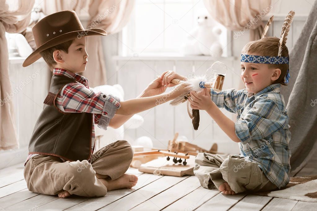 Boys as Indian and cowboy playing in her room